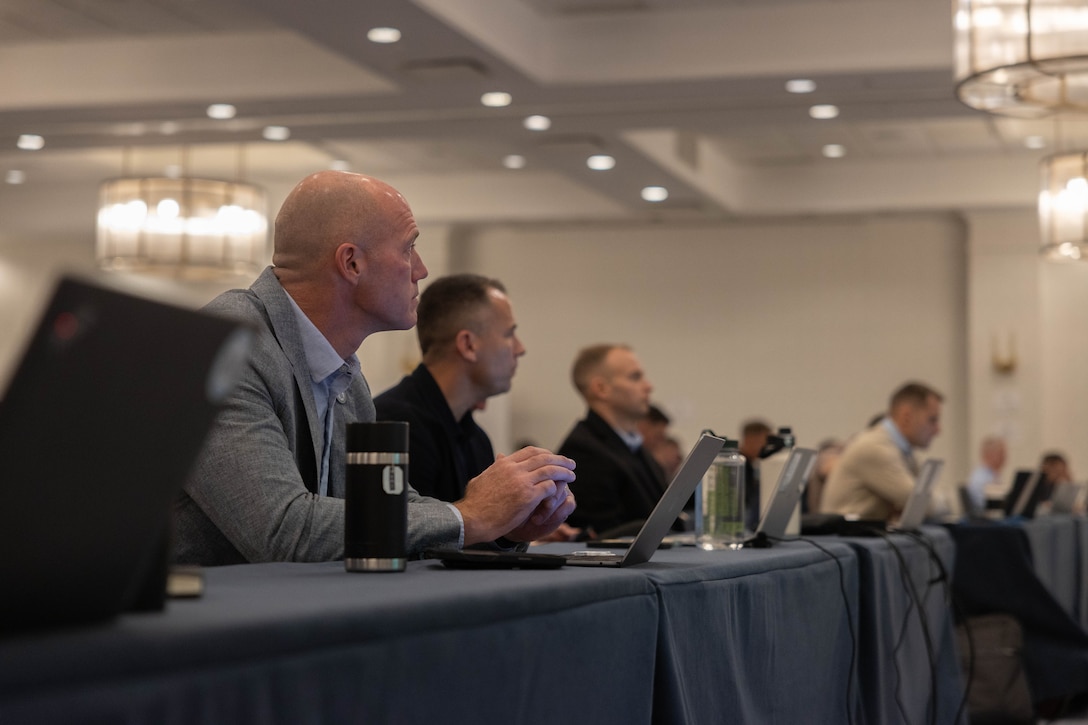 U.S. Marine Corps Col. Benjamin C. Richardson, commanding officer, Marine Innovation Unit, looks on during a town hall meeting with leadership from Force Headquarters Group, Marine Forces Reserve in White Plains, New York, Nov. 20, 2025. During the town hall, Brig. Gen. David K. Winnacker and Sgt. Maj. Russell D. Boley delivered remarks and answered questions from the Marine Innovation Unit. Established in 2022, the Marine Innovation Unit leverages the talent of the Marine Corps Reserve to accelerate the adoption of advanced capabilities, transform Naval Service capacity for technology employment, and retain and invest in Total Force human capital. (U.S. Marine Corps photo by Cpl. Kanoa Thomas)