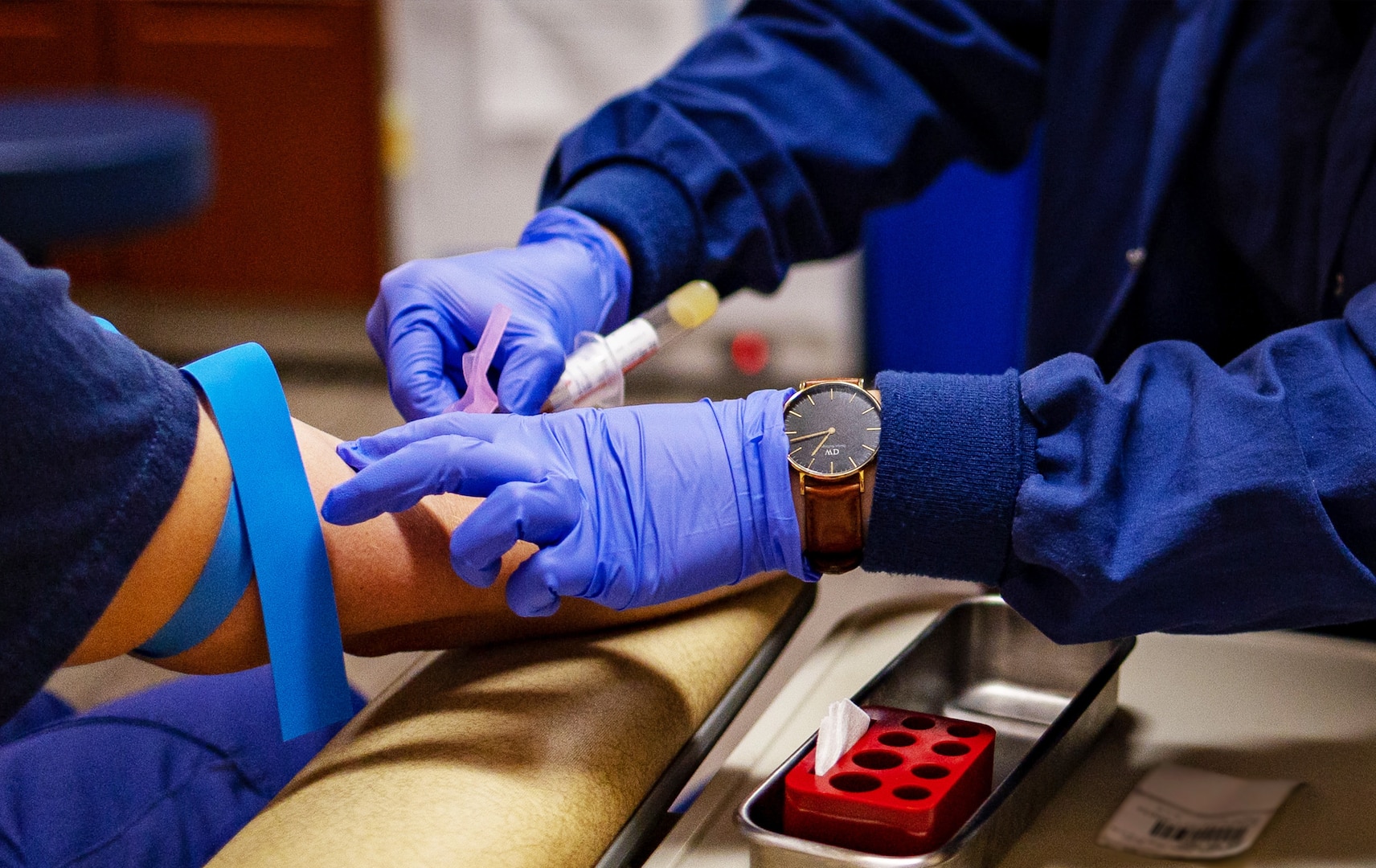 Petty Officer 1st Class Kina Thayer, a Health Services Technician at U.S. Coast Guard Yard Clinic, administers a routine blood withdrawal on a patient in Baltimore, Maryland, August 8, 2024.