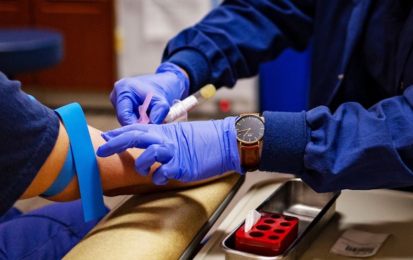 Petty Officer 1st Class Kina Thayer, a Health Services Technician at U.S. Coast Guard Yard Clinic, administers a routine blood withdrawal on a patient in Baltimore, Maryland, August 8, 2024. Health Services Technicians (HS) deliver vital medical care across a spectrum of operational environments, from clinics to sickbays ashore & afloat. (U.S. Coast Guard photo by Petty Officer 3rd Class Olinda Romero)