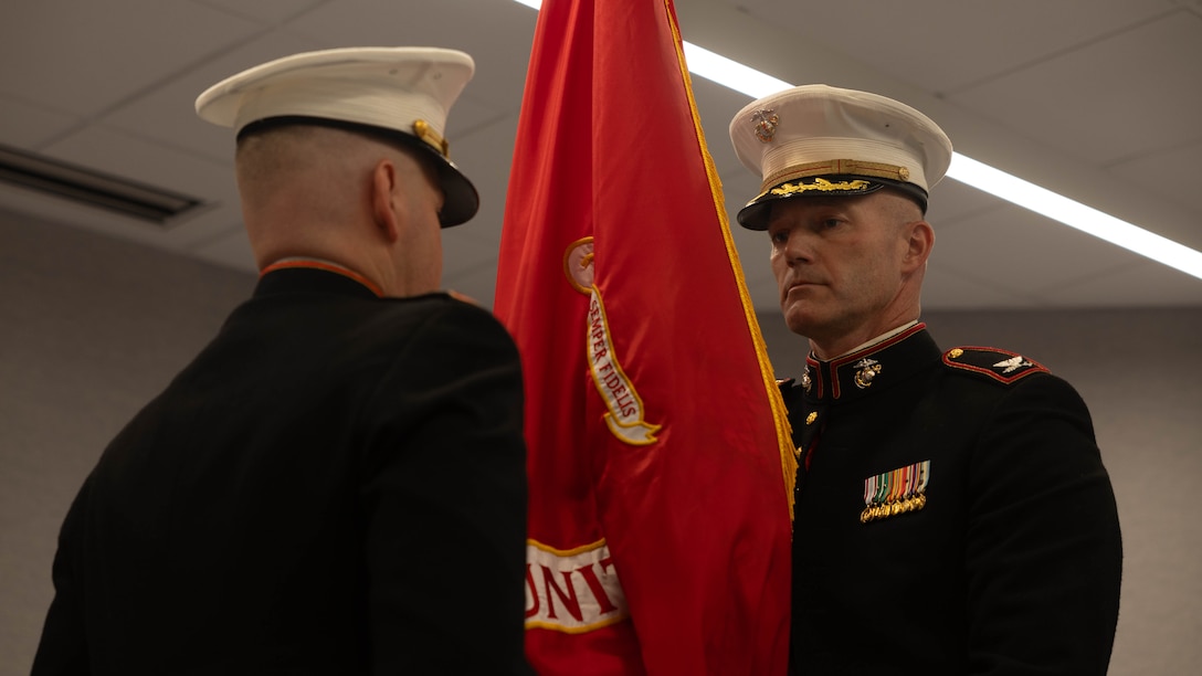 U.S. Marine Corps Col. Benjamin C. Richardson, right, receives the unit colors from Col. Brooks D. Braden during the Marine Innovation Unit’s change of command ceremony in White Plains, New York, Nov. 21, 2025. During the ceremony, Richardson assumed command of the Marine Innovation Unit from Braden. Established in 2022, the Marine Innovation Unit leverages the talent of the Marine Corps Reserve to accelerate the adoption of advanced capabilities, transform Naval Service capacity for technology employment, and retain and invest in Total Force human capital. (U.S. Marine Corps photo by Cpl. Kanoa Thomas)