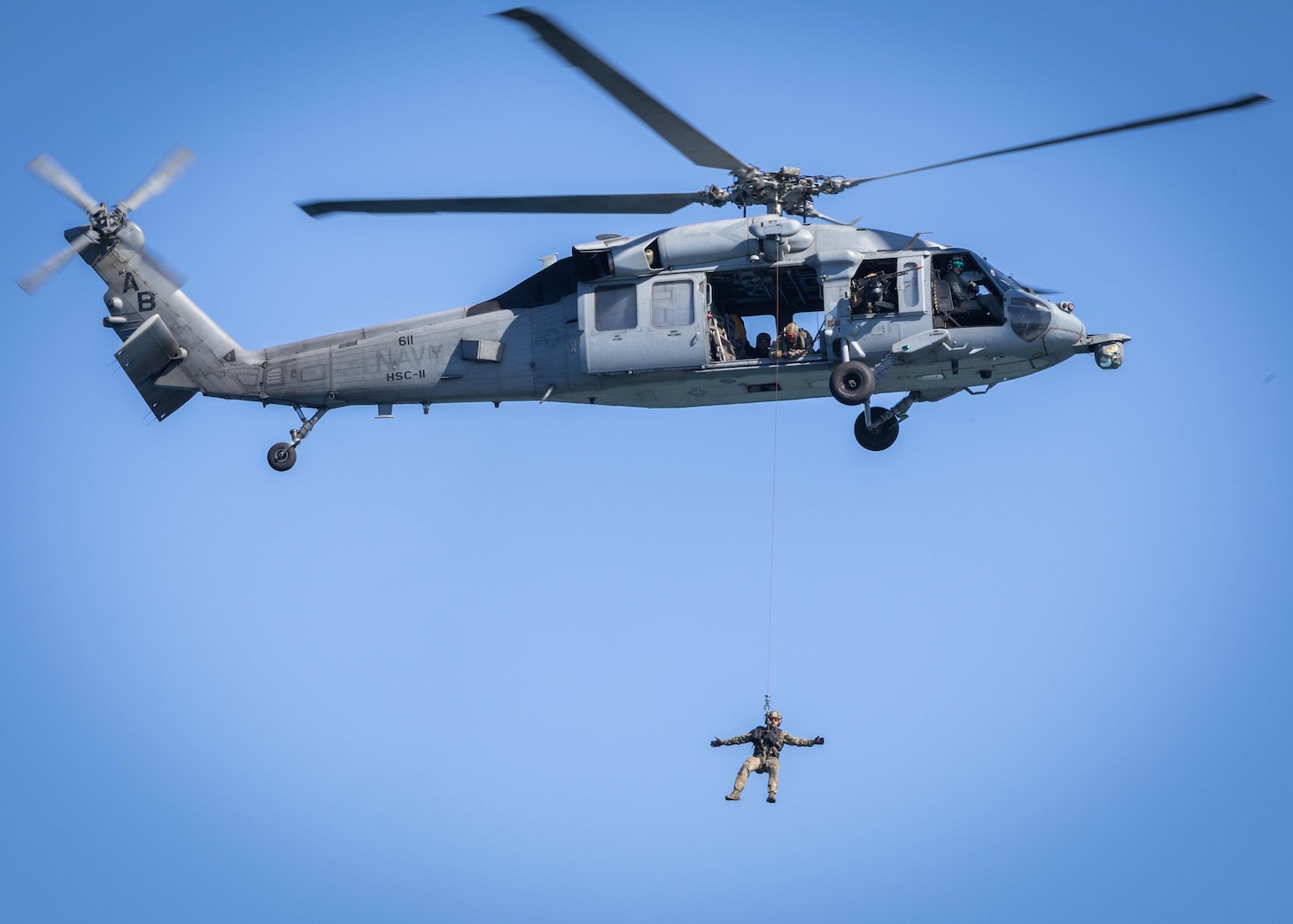 A Sailor descends from an MH-60S Sea Hawk attached to the “Dragonslayers” of Helicopter Sea Combat Squadron (HSC) 11 as it hovers next to the Nimitz-class aircraft carrier USS George H.W. Bush (CVN 77) in preparation for the Titans of the Sea Presidential Review. The Titans of the Sea Presidential Review is one of many events taking place throughout the country to showcase maritime capabilities as part of the U.S. Navy’s 250th birthday. America is a maritime nation. For 250 years, America’s Warfighting Navy has sailed the globe in defense of freedom.