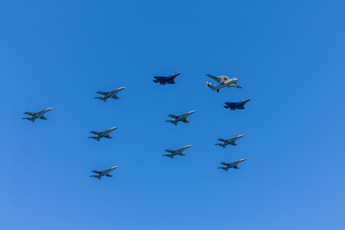 Eight F/A-18 Super Hornets, two F-35C Lightning IIs, and one E-2D Hawkeye conduct a carrier airwing flyover above the Nimitz-class aircraft carrier USS George H.W. Bush (CVN 77) during the Titans of the Sea Presidential Review. The Titans of the Sea Presidential Review is one of many events taking place throughout the country to showcase maritime capabilities as part of the U.S. Navy’s 250th birthday. America is a maritime nation. For 250 years, America’s Warfighting Navy has sailed the globe in defense of freedom.