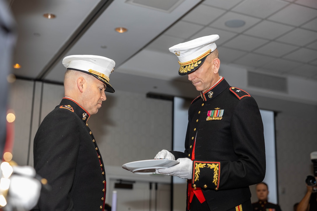 U.S. Marine Corps Brig. Gen. David K. Winnacker, right, commanding general, Force Headquarters Group, Marine Forces Reserve, receives the first piece of traditional Marine Corps birthday cake from Col. Brooks D. Braden, commanding officer, Marine Innovation Unit, Force Headquarters Group, Marine Forces Reserve, during the MIU's 250th Marine Corps Birthday Ball in White Plains, New York, Nov. 21, 2025. The birthday ball took place at the conclusion of MIU’s annual week-long training period, establishing objectives and plans for the coming year. Established in 2022, the MIU leverages the talent of the Marine Corps Reserve to accelerate the adoption of advanced capabilities, transform Naval Service capacity for technology employment, and retain and invest in Total Force human capital. (U.S. Marine Corps photo by Cpl. Kanoa Thomas)