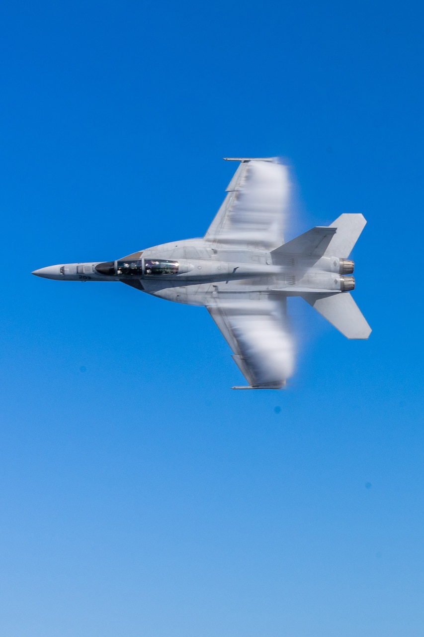 An F/A-18F attached to the “Pukin Dogs” of Strike Fighter Squadron (VFA) 143 conducts a pass over the Nimitz-class aircraft carrier USS George H.W. Bush (CVN 77) during the Titans of the Sea Presidential Review. The Titans of the Sea Presidential Review is one of many events taking place throughout the country to showcase maritime capabilities as part of the U.S Navy’s 250th birthday. America is a maritime nation. For 250 years, America’s Warfighting Navy has sailed the globe in defense of freedom.