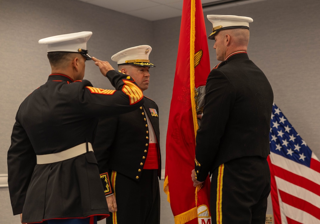 U.S. Marine Corps Master Gunnery Sgt. David A. Arellano salutes as Col. Benjamin C. Richardson, right, receives the unit colors from Col. Brooks D. Braden during the Marine Innovation Unit’s change of command ceremony in White Plains, New York, Nov. 21, 2025. During the ceremony, Richardson assumed command of the Marine Innovation Unit from Braden. Established in 2022, the Marine Innovation Unit leverages the talent of the Marine Corps Reserve to accelerate the adoption of advanced capabilities, transform Naval Service capacity for technology employment, and retain and invest in Total Force human capital. (U.S. Marine Corps photo by Cpl. Kanoa Thomas)