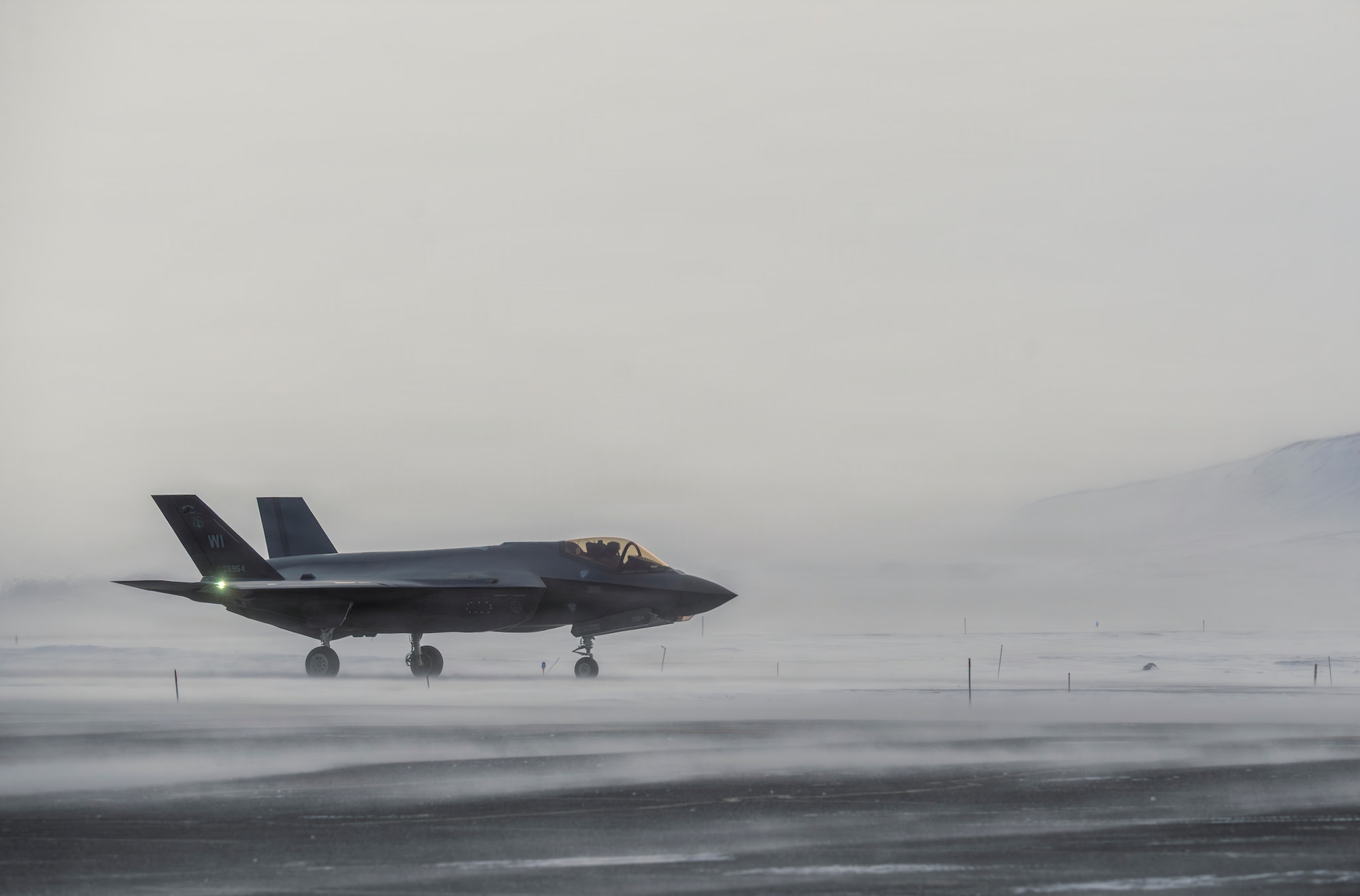 A North American Aerospace Defense Command F-35 Lightning II fighter aircraft sits on the tarmac at Pituffik Space Force Base, Greenland.