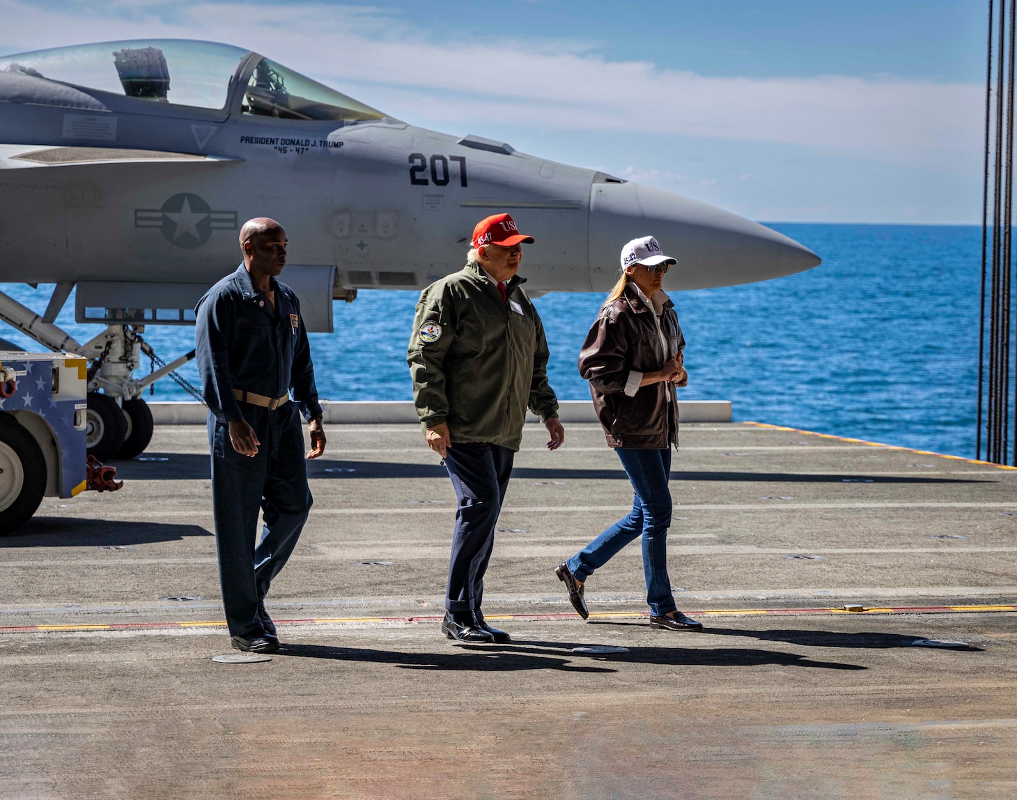 President Donald J. Trump, middle, First Lady Melania Trump, right, and Rear Adm. Alexis Walker, commander, Carrier Strike Group 10, participate in a Titans of the Sea Presidential Review aboard the Nimitz-class aircraft carrier USS George H.W. Bush (CVN 77). The Titans of the Sea Presidential Review is one of many events taking place throughout the country to showcase maritime capabilities as part of the U.S. Navy’s 250th birthday. America is a maritime nation. For 250 years, America’s Warfighting Navy has sailed the globe in defense of freedom.