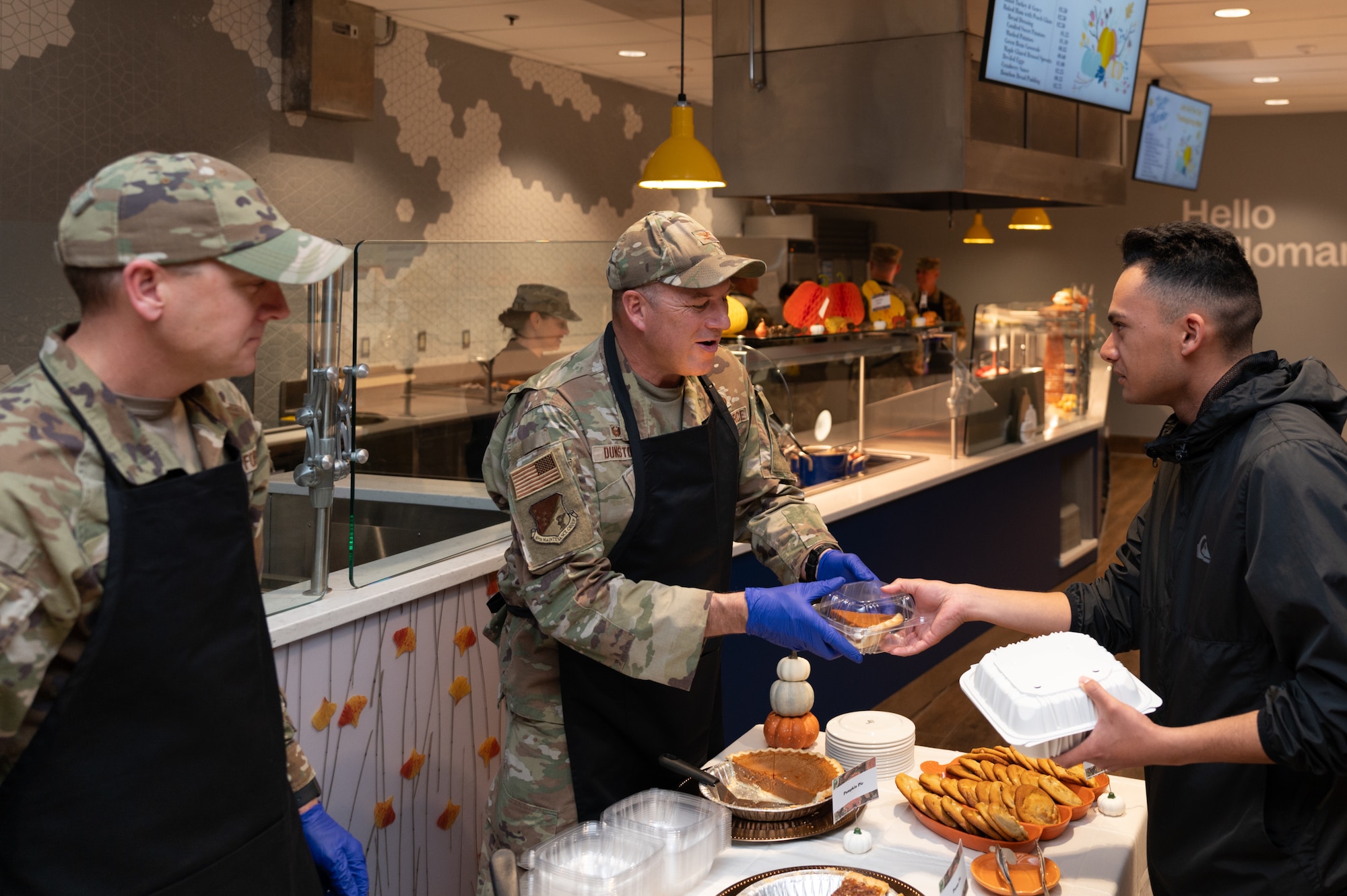U.S. Air Force Col. Christopher Dunston, 49th Maintenance Group Commander, center, gives out Thanksgiving dessert at the Shifting Sands Dining Facility at Holloman Air Force Base, Nov. 27, 2025.