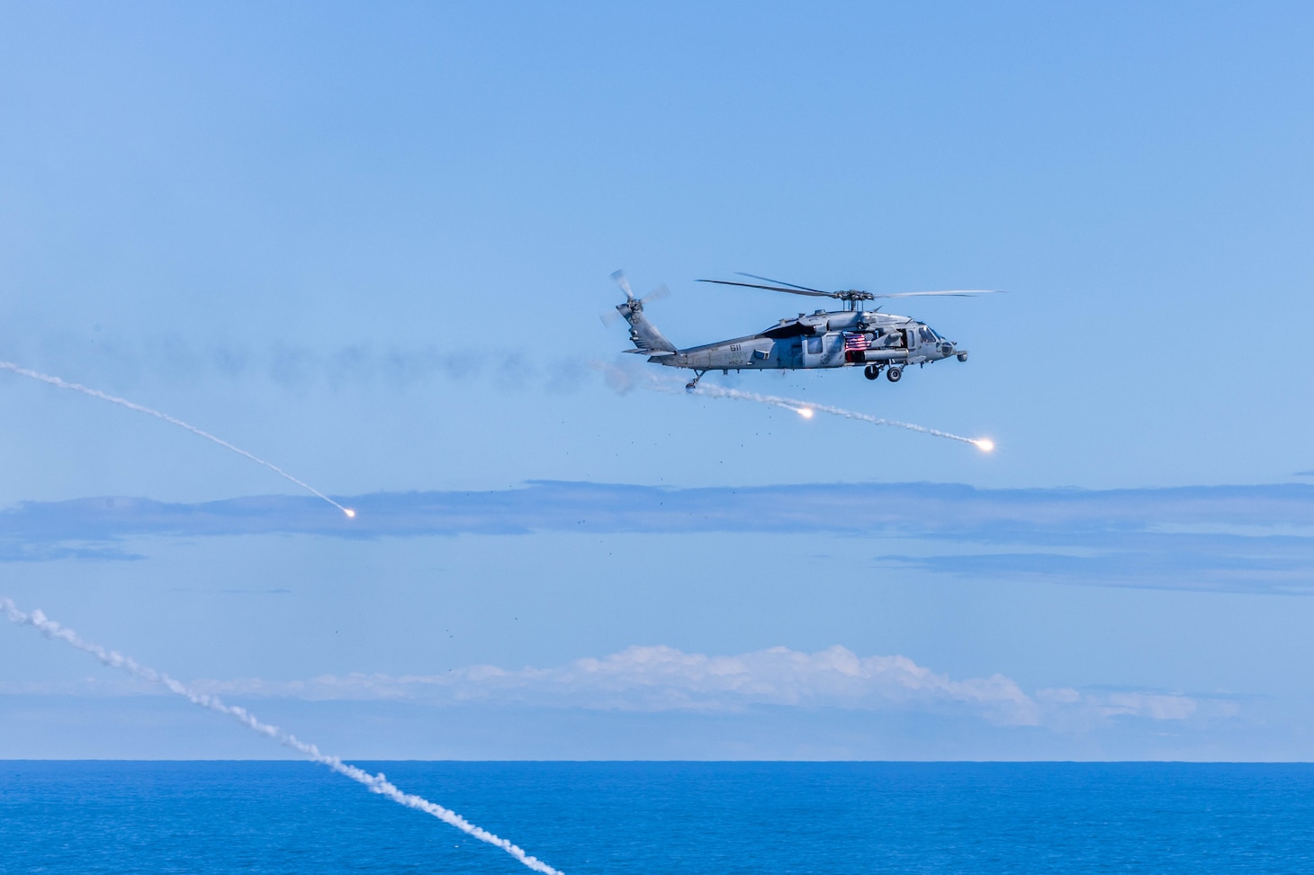 An MH-60S Sea Hawk attached the “Dusty Dogs” of Helicopter Sea Combat Squadron (HSC) 7 launches flares during an air demonstration for the Titans of the Sea Presidential Review aboard the Nimitz-class aircraft carrier USS George H.W. Bush (CVN 77). The Titans of the Sea Presidential Review is one of many events taking place throughout the country to showcase maritime capabilities as part of the U.S. Navy’s 250th birthday. America is a maritime nation. For 250 years, America’s Warfighting Navy has sailed the globe in defense of freedom.