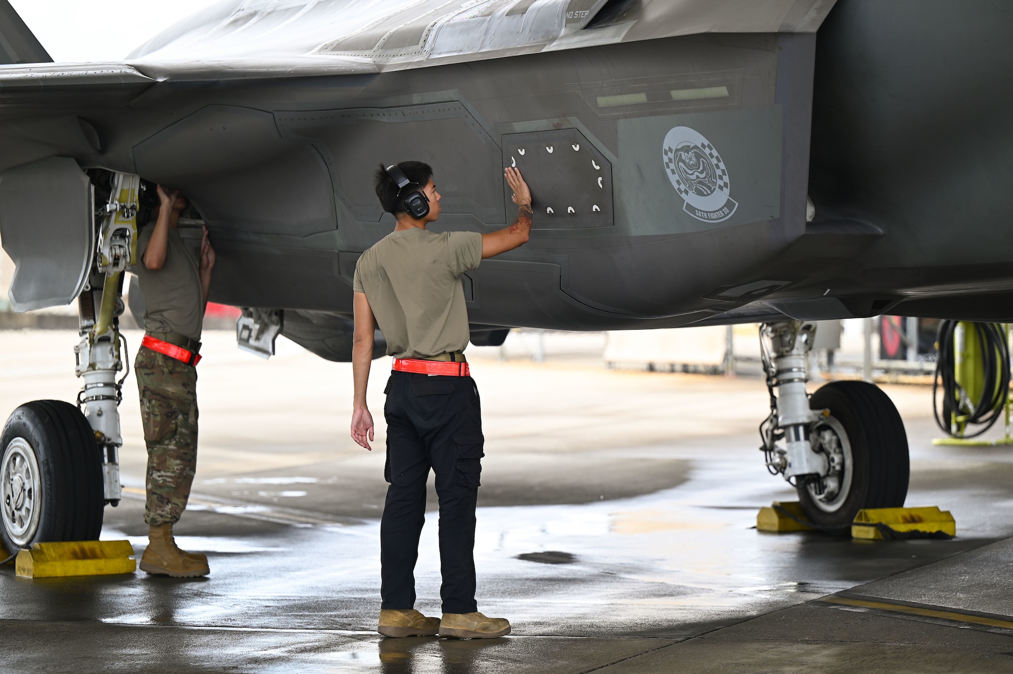 An airman prepping a jet