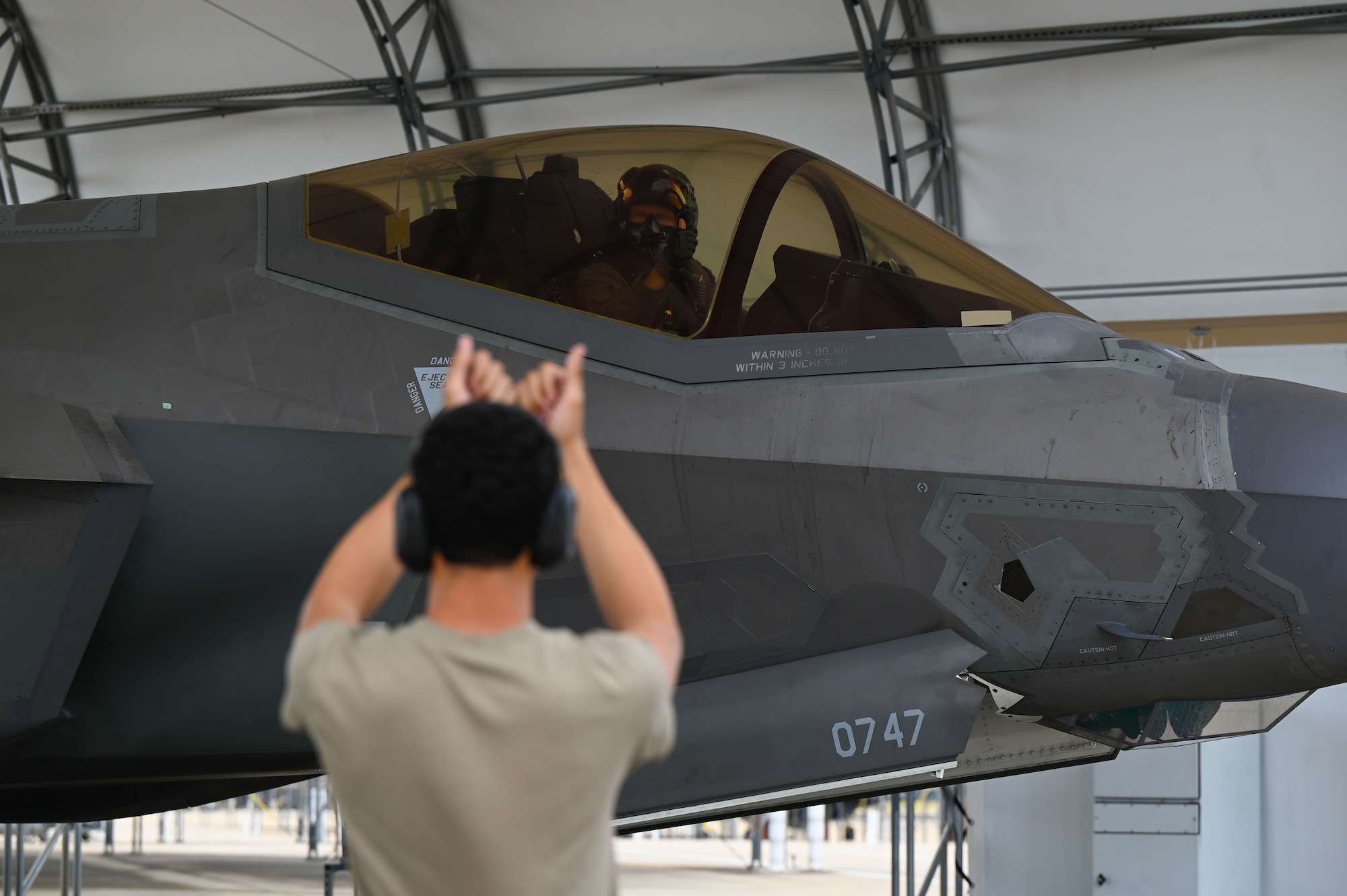 An airman taxiing a jet