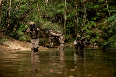 OKINAWA, Japan (Nov. 4, 2025) — U.S. Marines with 7th Communication Battalion, III Marine Expeditionary Force Information Group, patrol on an obstacle course during Operation Odyssey Stormbreaker III at Jungle Warfare Training Center, Okinawa,...