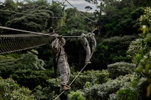 U.S. Marines with 7th Communication Battalion, III Marine Expeditionary Force Information Group, conduct an obstacle course during Operation Odyssey Stormbreaker III at Jungle Warfare Training Center, Okinawa, Japan, Nov. 4, 2025.