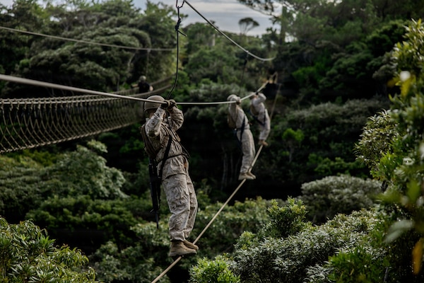 U.S. Marines with 7th Communication Battalion, III Marine Expeditionary Force Information Group, conduct an obstacle course during Operation Odyssey Stormbreaker III at Jungle Warfare Training Center, Okinawa, Japan, Nov. 4, 2025.