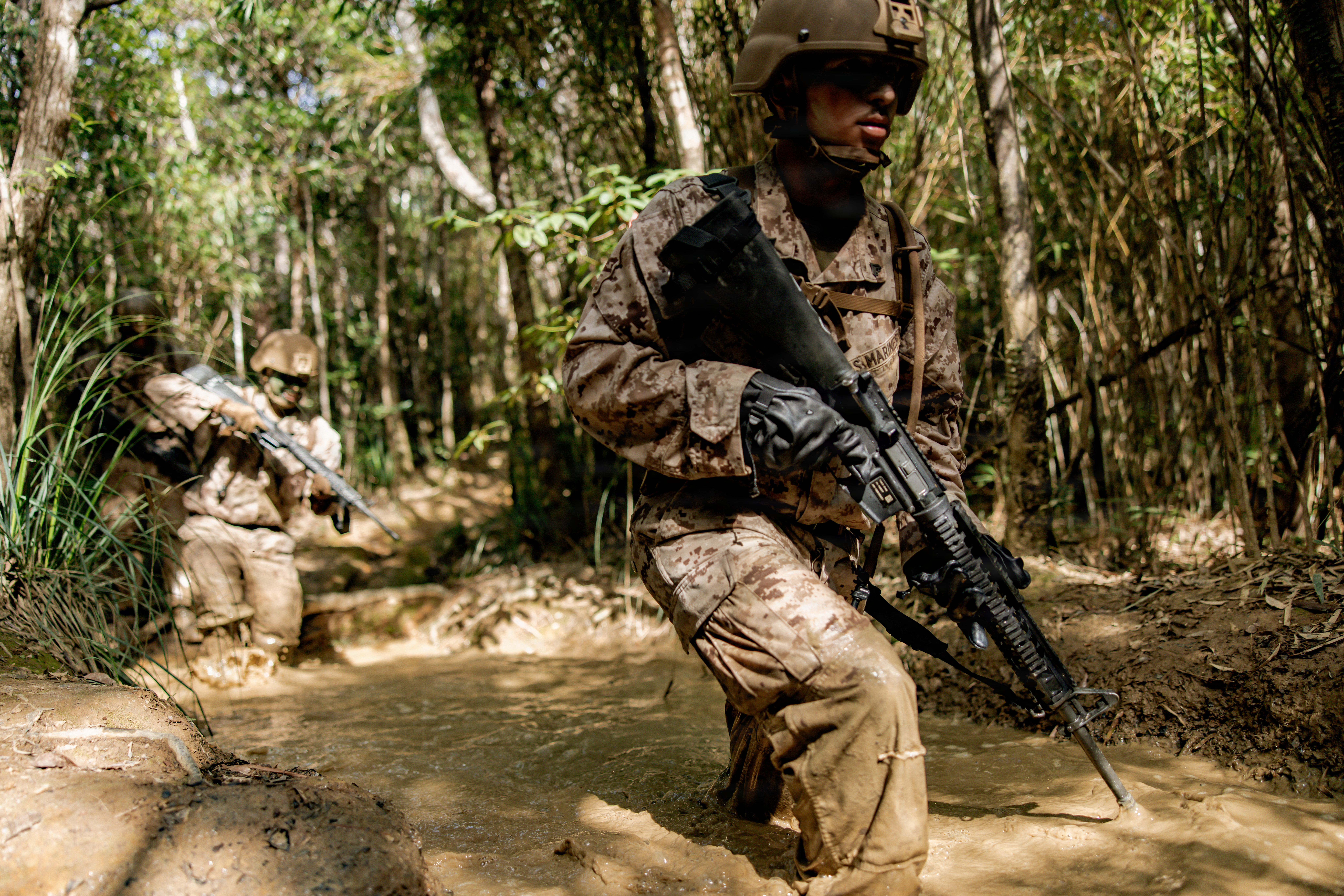 U.S. Marine Corps Cpl. Brandon Aguilar, a native of California and a satellite communications operator maintainer with 7th Communication Battalion, III Marine Expeditionary Force Information Group, patrols on an obstacle course during Operation Odyssey Stormbreaker III at Jungle Warfare Training Center, Okinawa, Japan, Nov. 4, 2025.