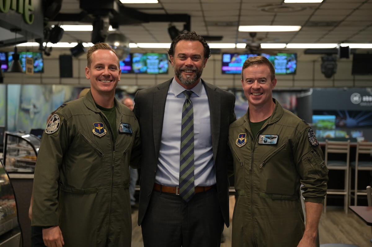 U.S. Air Force Capt. Tyler “Hype” Lannom, instructor pilot 49th Flying Training Squadron (left), the Under Secretary of the Air Force Matthew Lohmeier (middle), and U.S. Air Force Lt. Col. John “Rowdy” Little, 49th FTS commander (right), stand together for a group photo at the bowling center