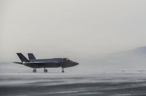 A North American Aerospace Defense Command F-35 Lightning II fighter aircraft sits on the tarmac at Pituffik Space Force Base, Greenland.