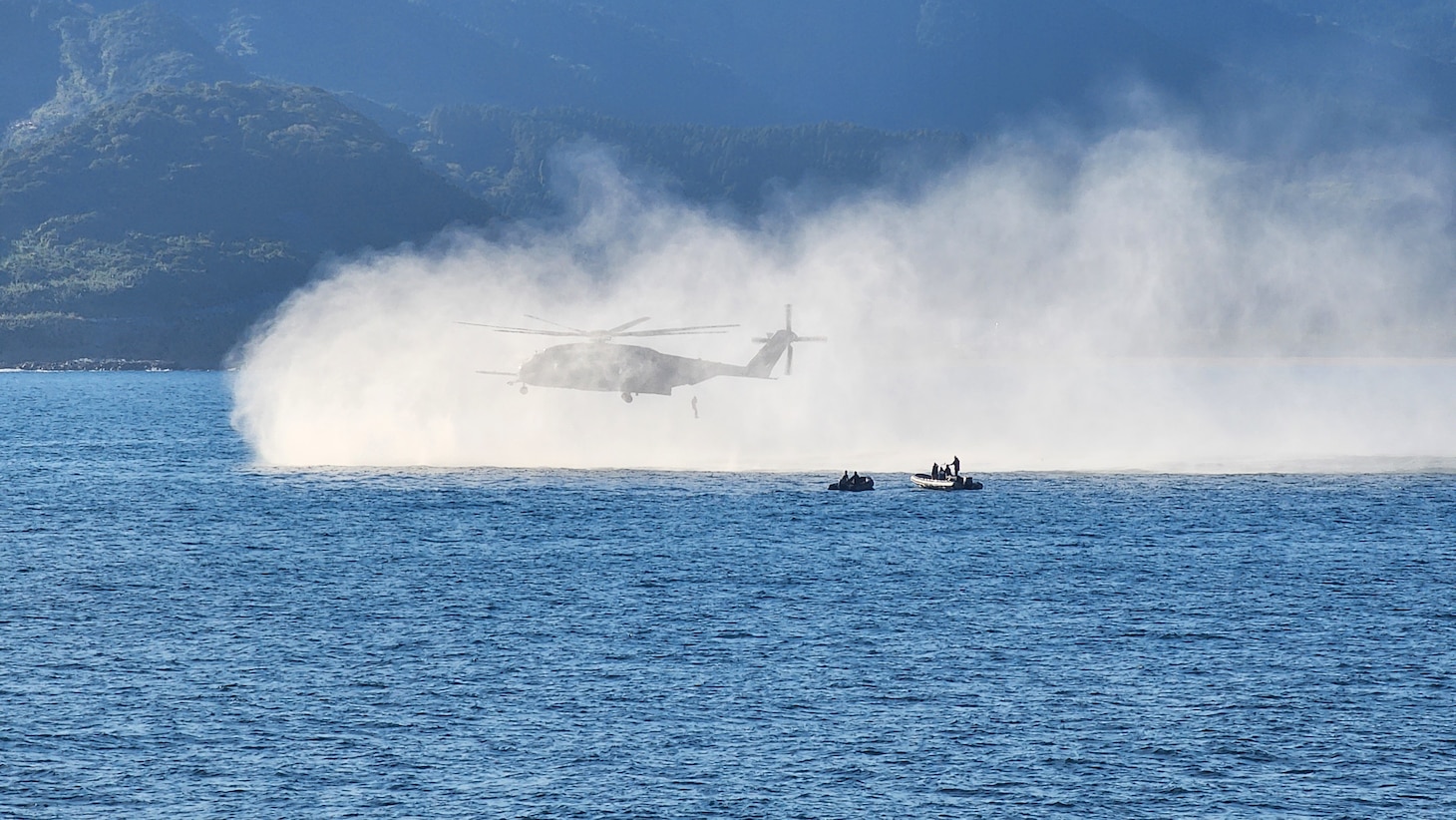 Explosive Ordnance Disposal Mobile Unit (EODMU) 5 Expeditionary Mine Countermeasures (ExMCM) Company 9-3 and Japan Maritime Self-Defense Force (JMSDF) EOD teams jump from an MH-53E Sea Dragon from Helicopter Mine countermeasures squadron 15 (HM-15) during a helicopter casting exercise as part of Mine Warfare Exercise (MINEX) 3JA, Nov. 22, 2025.