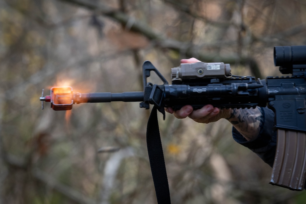 A U.S. Air Force Airman assigned to the 52nd Security Forces Squadron fires blanks while acting as an opposing force during the first Airman Leadership School field training exercise at Spangdahlem Air Base, Germany, Nov. 6, 2025. Volunteers posed as OPFOR during the exercise to help create a more immersive training environment for ALS Airmen. (U.S. Air Force photo by Airman 1st Class Sydney Franklin)