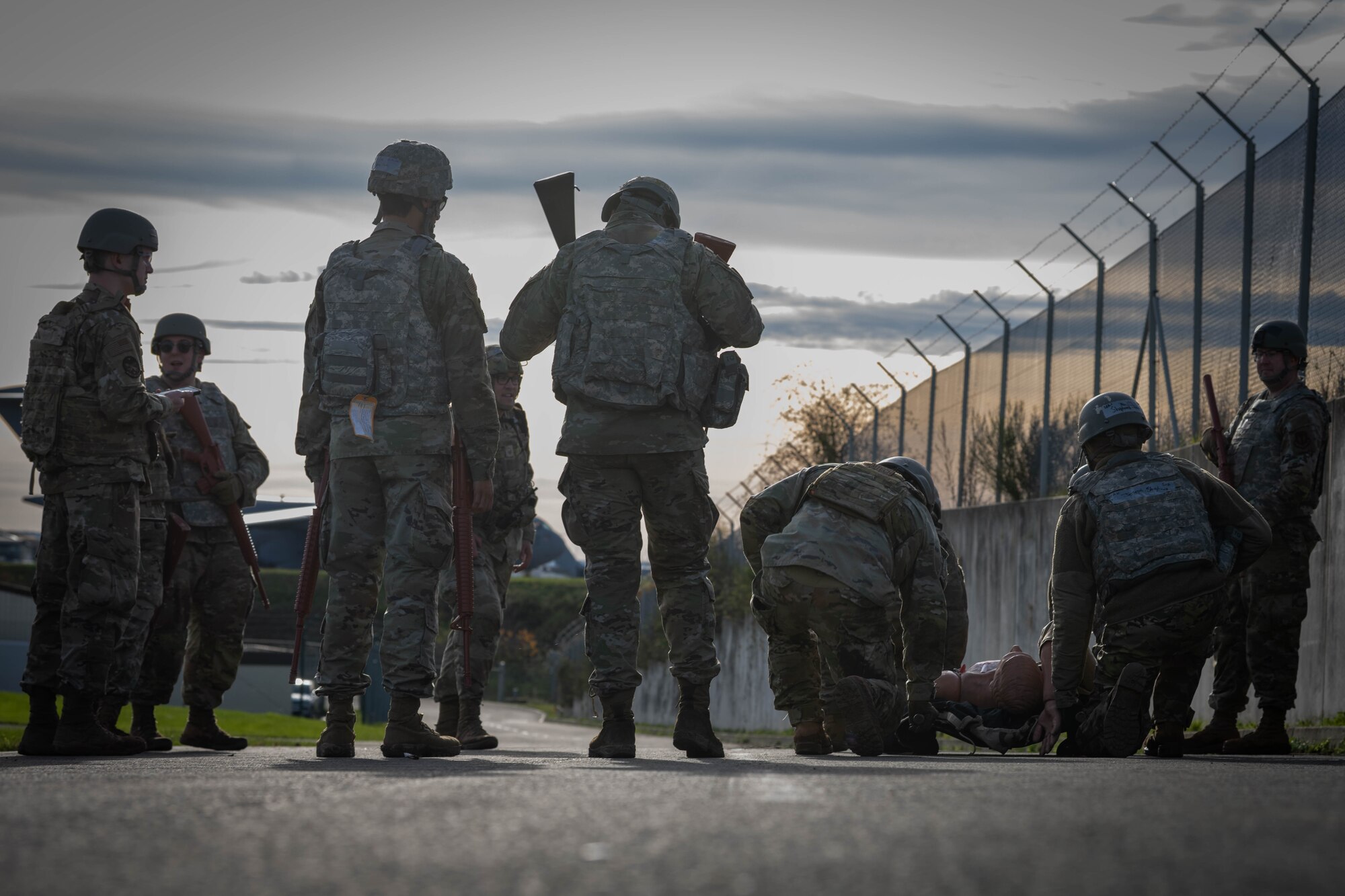 U.S. Air Force Airmen assigned to the 52nd Fighter Wing carry a simulated casualty during the first Airman Leadership School field training exercise at Spangdahlem Air Base, Germany, Nov. 6, 2025. The scenario required students to coordinate as a team under time sensitive conditions, challenging their ability to think critically and communicate effectively. (U.S. Air Force photo by Airman 1st Class Sydney Franklin)