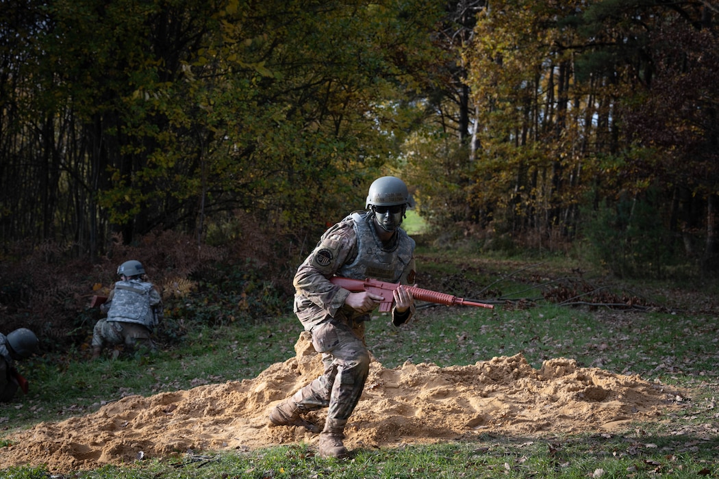 U.S. Air Force Senior Airman Ryan Sullivan, 52nd Civil Engineer Squadron electrical systems specialist, runs to cover during the first Airman Leadership School field training exercise at Spangdahlem Air Base, Germany, Nov. 6, 2025. The scenario placed Sullivan and other Airmen in a simulated combat environment designed to challenge the future noncommissioned officers to lead, communicate and make quick decisions under pressure. (U.S. Air Force photo by Airman 1st Class Sydney Franklin)