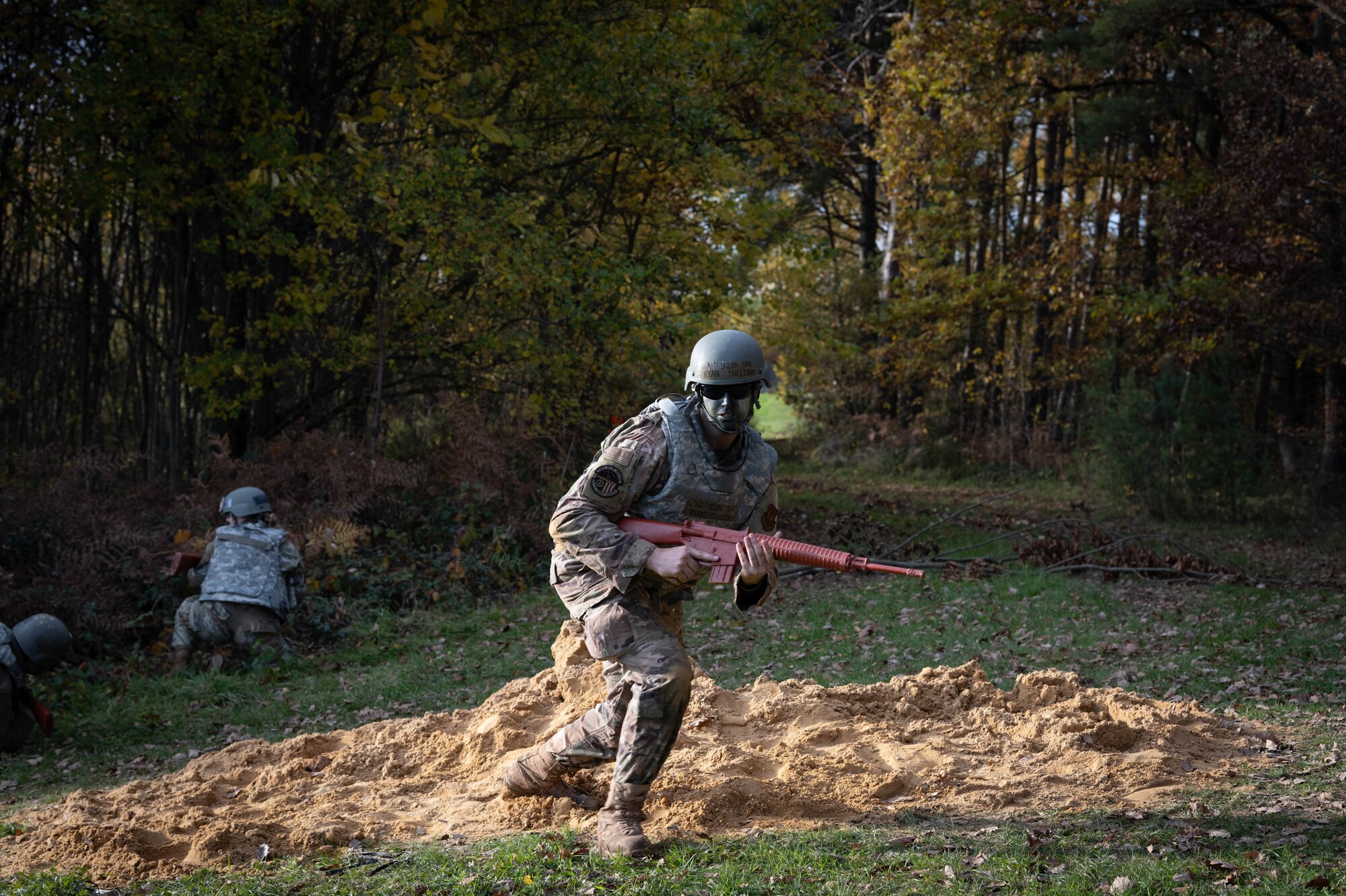 U.S. Air Force Senior Airman Ryan Sullivan, 52nd Civil Engineer Squadron electrical systems specialist, runs to cover during the first Airman Leadership School field training exercise at Spangdahlem Air Base, Germany, Nov. 6, 2025. The scenario placed Sullivan and other Airmen in a simulated combat environment designed to challenge the future noncommissioned officers to lead, communicate and make quick decisions under pressure. (U.S. Air Force photo by Airman 1st Class Sydney Franklin)