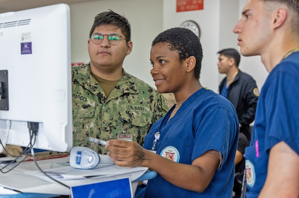 YOKOSUKA, Japan (Oct. 3, 2025) – USNH Yokosuka personnel coordinate patient check-in using the hospital’s automated registration system inside the Command Auditorium during staff influenza vaccinations. Over the course of the 2025 flu shot events, vaccination teams administered more than 6,800 doses, efficiently protecting thousands across the installation. First introduced in 2024, the system streamlined workflow, reduced wait times, and improved documentation accuracy. (U.S. Navy photo by USNMRTC Yokosuka Public Affairs/Daniel Taylor)