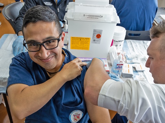 YOKOSUKA, Japan (Oct. 3, 2025) – A Hospital Corpsman administers an influenza vaccine to a USNH Yokosuka staff member in the Command Auditorium during the start of the hospital’s 2025 influenza vaccination season. Over the course of the 2025 flu shot events, USNH Yokosuka’s vaccination teams administered more than 6,800 doses, efficiently protecting thousands across the installation. The hospital’s annual campaign strengthens medical readiness and protects the health of Sailors, families, and civilian staff.  (U.S. Navy photo by USNMRTC Yokosuka Public Affairs/Daniel Taylor)