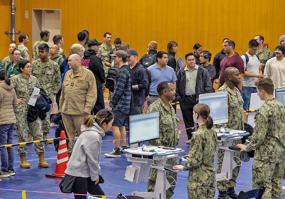 YOKOSUKA, Japan (Oct. 23, 2025) – Service members, families, and civilians line up inside the Fleet Recreation Center Gym on Commander, Fleet Activities Yokosuka during a mass vaccination event supporting USNH Yokosuka’s 2025 influenza vaccination campaign. Over the course of the 2025 flu shot events, USNH Yokosuka’s vaccination teams administered more than 6,800 doses, efficiently protecting thousands across the installation. The hospital’s annual campaign strengthens medical readiness and protects the health of Sailors, families, and civilian staff. (U.S. Navy photo by USNMRTC Yokosuka Public Affairs/Daniel Taylor)