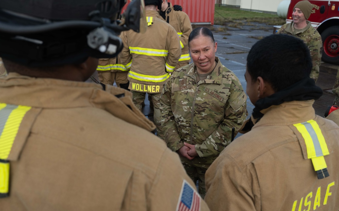 U.S. Air Force Chief Master Sgt. Mary Trent, 52nd Fighter Wing command chief, speaks with firefighters assigned to 52nd Civil Engineer Squadron Fire and Emergency Services about their Prime Base Emergency Engineer Force (Prime BEEF) training at Spangdahlem Air Base, Germany, Nov. 20, 2025. Prime BEEF teams provide a wide range of engineering and emergency services capabilities, including airfield damage repair, facility construction, and fire protection, enabling rapid response to contingencies worldwide. (U.S. Air Force photo by Senior Airman Darius Frazier)