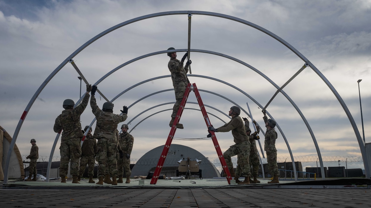U.S. Air Force Airmen assigned to the 52nd Civil Engineer Squadron assemble a small shelter system during a Prime Base Emergency Engineer Force (Prime BEEF) training at Spangdahlem Air Base, Germany, Nov. 20, 2025.  Recurring Prime BEEF training ensures the squadron is ready to rapidly establish and maintain forward operating bases worldwide. (U.S. Air Force photo by Senior Airman Darius Frazier)