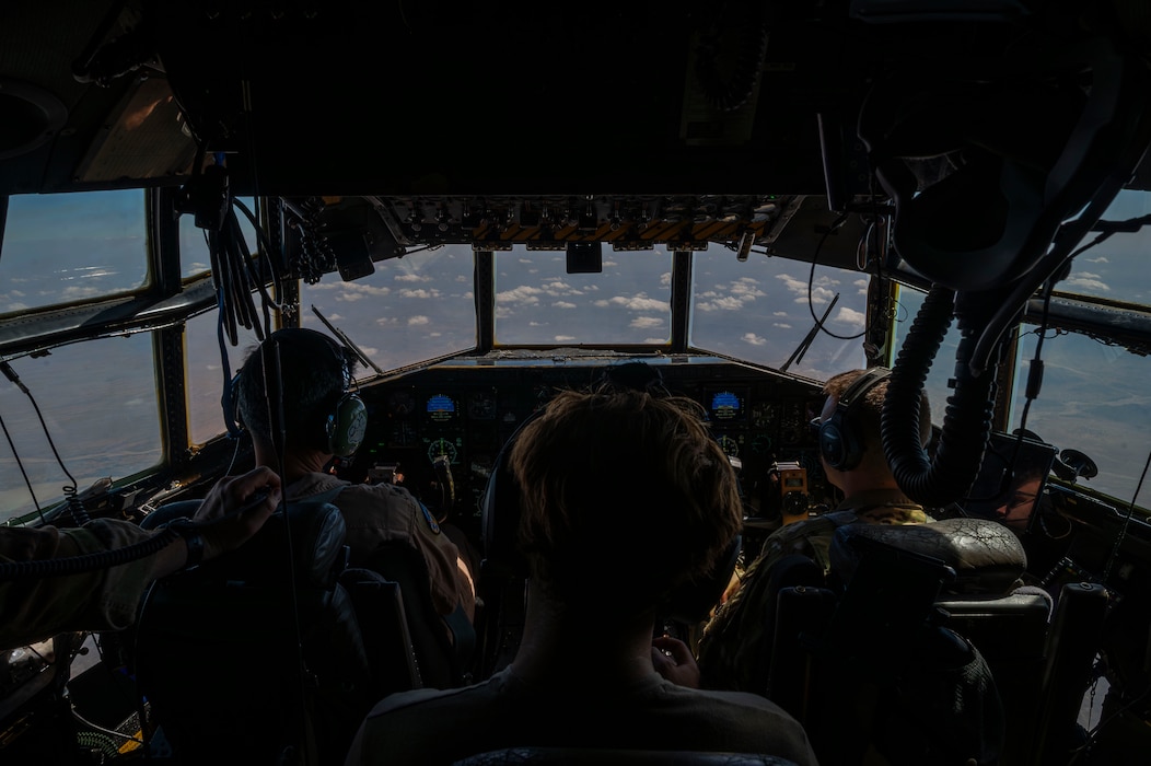Airmen of the 75th Expeditionary Airlift Squadron fly a C-130H Hercules cargo aircraft