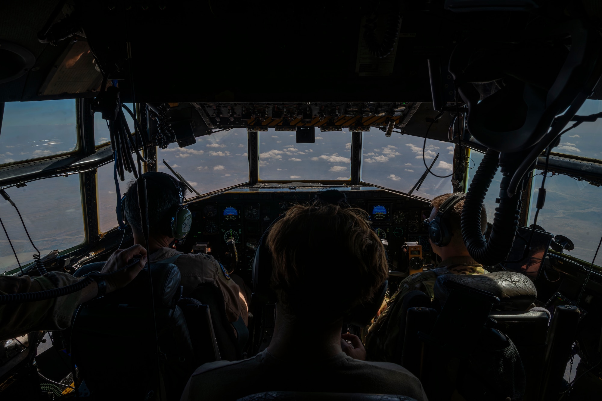 Airmen of the 75th Expeditionary Airlift Squadron fly a C-130H Hercules cargo aircraft
