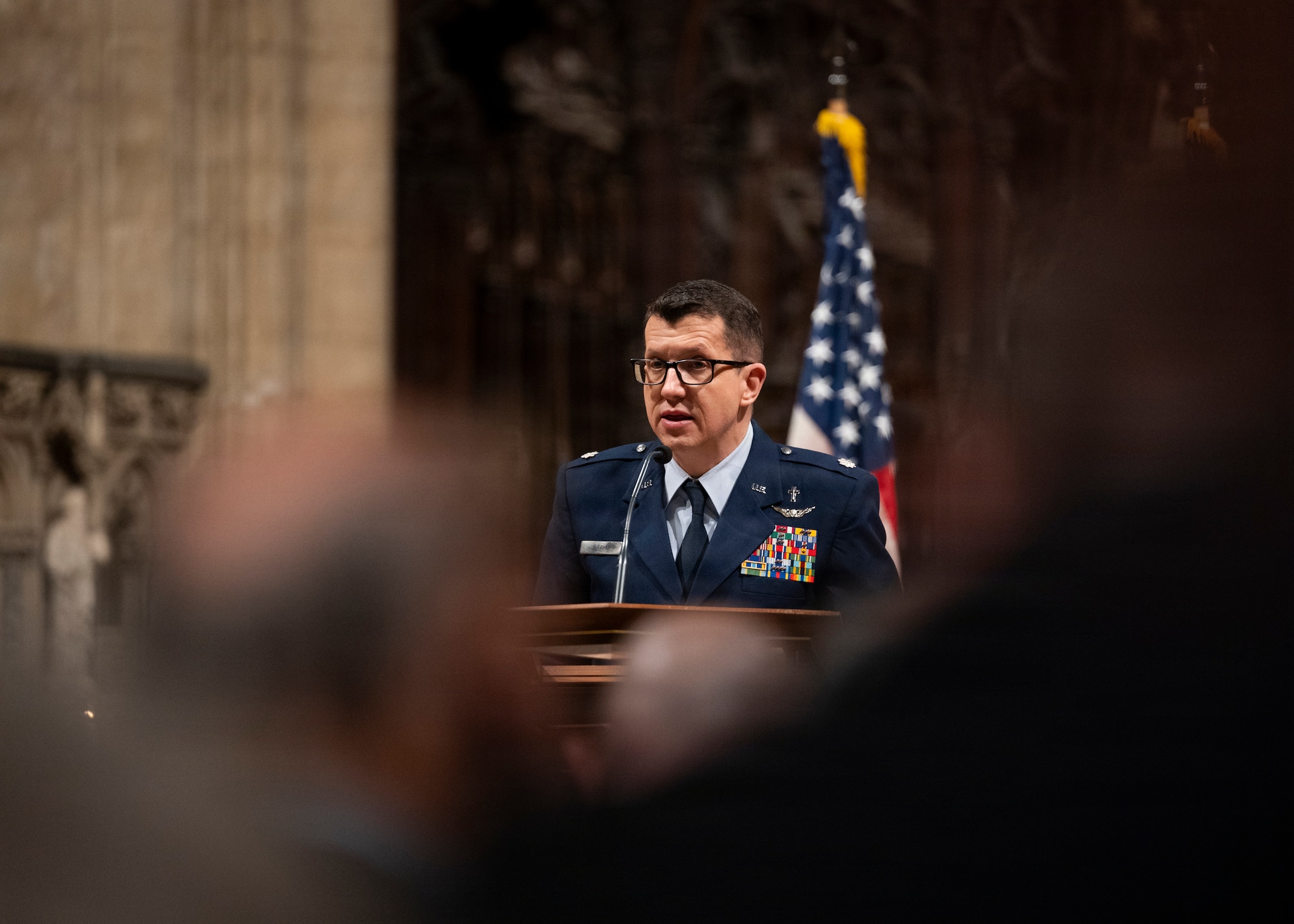 Lt. Col. Kelly Stahl, 48th Fighter Wing, wing chaplain, speaks to the gathered assembly at Ely Cathedral, Nov. 26, 2025. Ely Cathedral has partnered with the tribase area for the past 39 years to host a traditional service for U.S. service members during the Thanksgiving holiday. (U.S. Air Force photo by Staff Sgt. Nash Truitt)