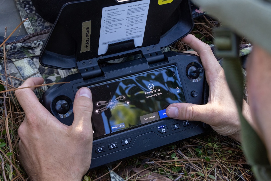 U.S. Naval Academy Midshipmen 3rd Class Carter Breen, an Ohio native, prepares a SkydioX2D small Unmanned Aircraft System for flight during a Marine Corps Combat Readiness Evaluation on Marine Corps Base Camp Lejeune, North Carolina, Oct. 20, 2025.