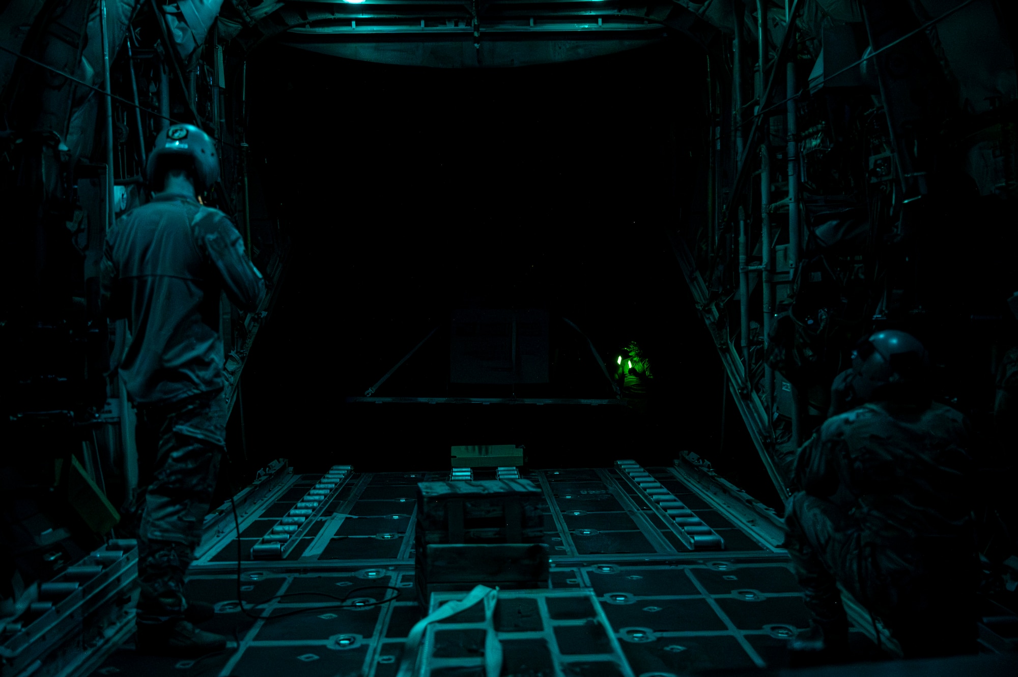 U.S. Air Force loadmasters assigned to the 75th Expeditionary Airlift Squadron load a pallet of cargo onto a C-130H Hercules