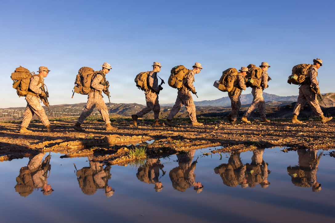 U.S. Marines with Headquarters Company, 5th Marine Regiment, 1st Marine Division participate in a company hike at Marine Corps Base Camp Pendleton, California, Nov. 26, 2025. The purpose of the hike was to test physical readiness and improve combat conditioning. (U.S. Marine Corps photo by Sgt. Kyle Chan)