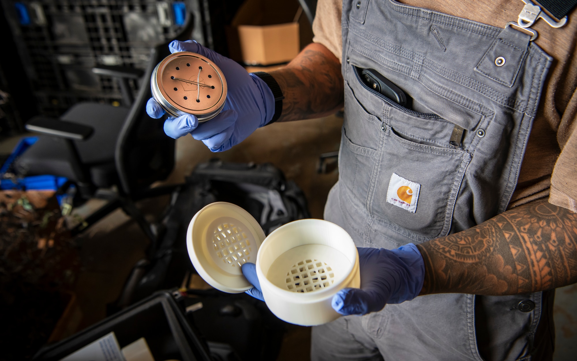 U.S Air Force Staff Sgt. Edwin Argueta-Hernandez, 436th Security Forces Squadron military working dog trainer, places a tin of narcotics into a Narcotics Printed Protection Enclosure (NPPE) at Dover Air Force Base, Oct. 15, 2025. The NPPE has been in development for a little over a year and was designed by the Joint Military Working Dog Laboratory within the Forensic Toxicology department of the Armed Forces Medical Examiner System on Dover AFB. These casings were developed to not only offer greater protection but to expand training possibilities for MWD handlers. (U.S. Air Force photo by Staff Sgt. Noah D. Coger)