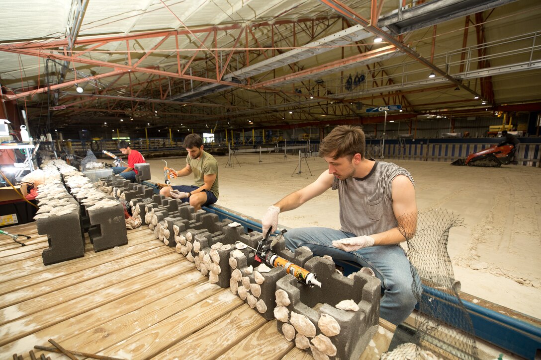 A group of research students construct model oyster shell reefs during the U.S. Coastal Research Program’s Sediment Transport Collaborative Laboratory Experiment, or SEDCOLAB, hosted by the U.S. Engineer Research and Development Center’s Coastal and Hydraulics Laboratory in Vicksburg, Miss., June 6, 2025.
