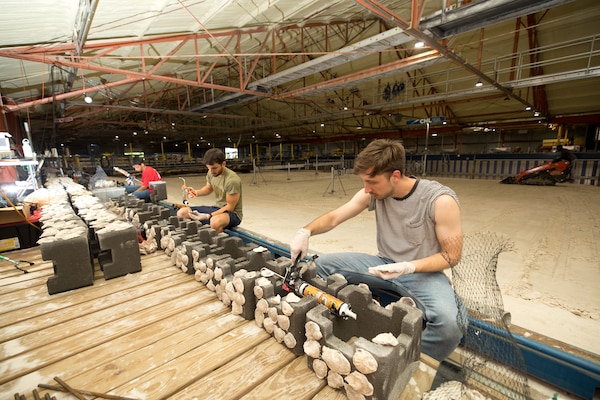 A group of research students construct model oyster shell reefs during the U.S. Coastal Research Program’s Sediment Transport Collaborative Laboratory Experiment, or SEDCOLAB, hosted by the U.S. Engineer Research and Development Center’s Coastal and Hydraulics Laboratory in Vicksburg, Miss., June 6, 2025.