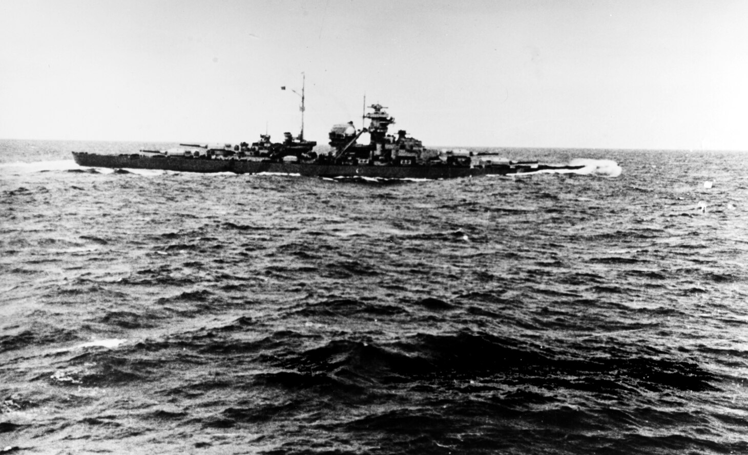 Photographed from the heavy cruiser Prinz Eugen on 24 May 1941, following the Battle of the Denmark Strait and before the two German ships separated. Bismarck is somewhat down by the bow, the result of hits received in her engagement with HMS Prince of Wales and HMS Hood earlier in the day. This is the next to last photograph of Bismarck taken by the Germans.  Copied from the report of officers of Prinz Eugen, with identification by her Gunnery Officer, Paul S. Schmalenbach, 1970.
