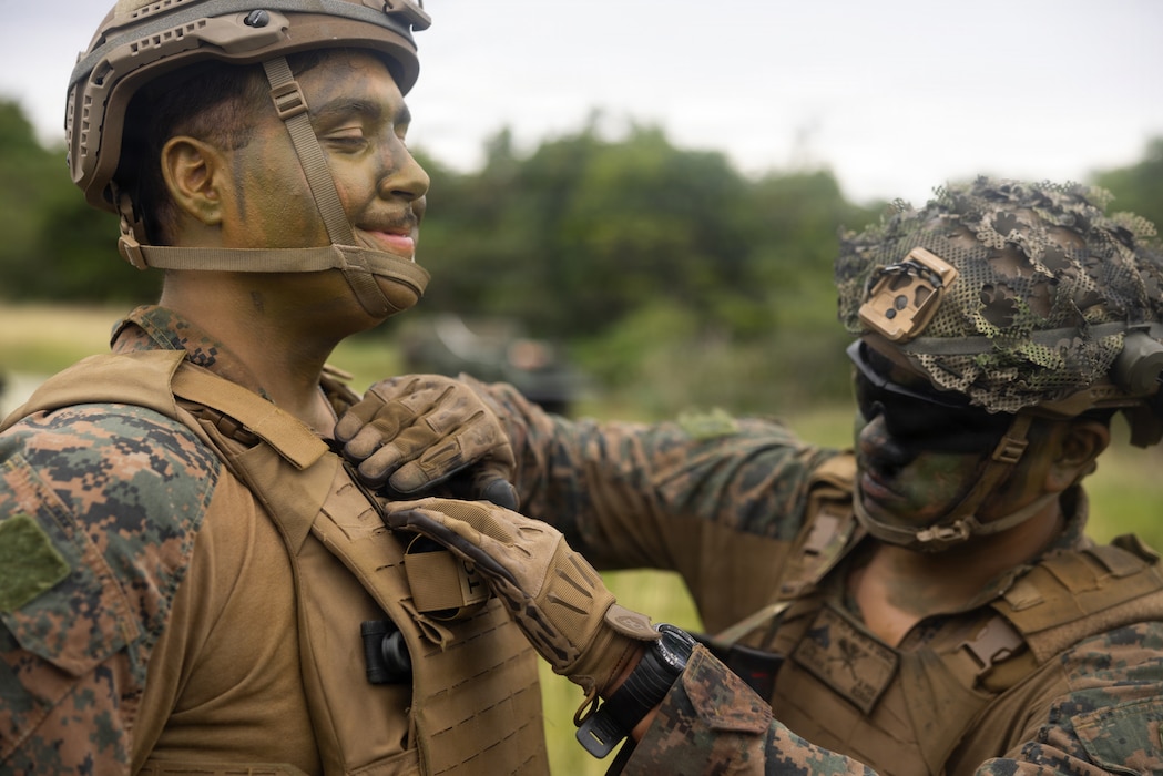 U.S. Navy Hospital Corpsman Seaman John Wortham, left, with 1st Low Altitude Air Defense, forward deployed in direct support of 4th Marine Regiment, 3rd Marine Division as part of the Unit Deployment Program, pins to the rank of Hospital Corpman 3rd Class on Camp Schwab, Okinawa, Japan, Nov. 19, 2025. The promotion to the rank of Petty Officer 3rd Class marks the Sailors’ entrance into the Noncommissioned Officer ranks of the U.S. Navy, signifying increased expectations of responsibility and leadership. Wortham is a native of Florida (U.S. Marine Corps photo by Lance Cpl. Tucker Mocan)