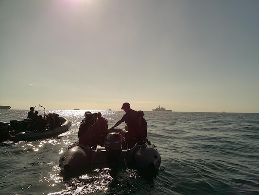 Explosive Ordnance Disposal Mobile Unit (EODMU) 5  Expeditionary Mine Countermeasures (ExMCM) Company 9-3 and Japan Maritime Self-Defense Force EOD teams transit back to the Uraga-class mine countermeasure vessel JS Uraga after completing unmanned underwater vehicle and dive operations during Mine Warfare Exercise (MINEX) 3JA, Nov. 19, 2025.