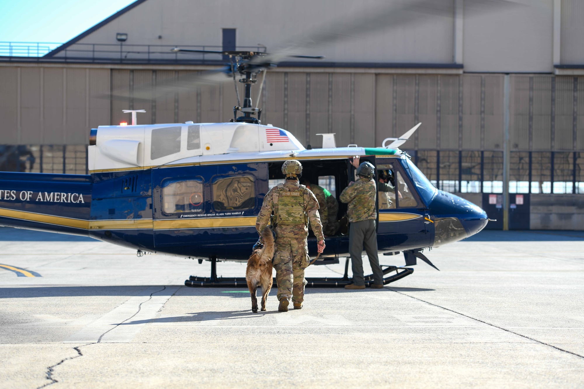Trainer and dog enter a helicopter