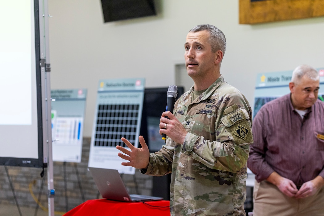 A man presents a slideshow to a group of people.