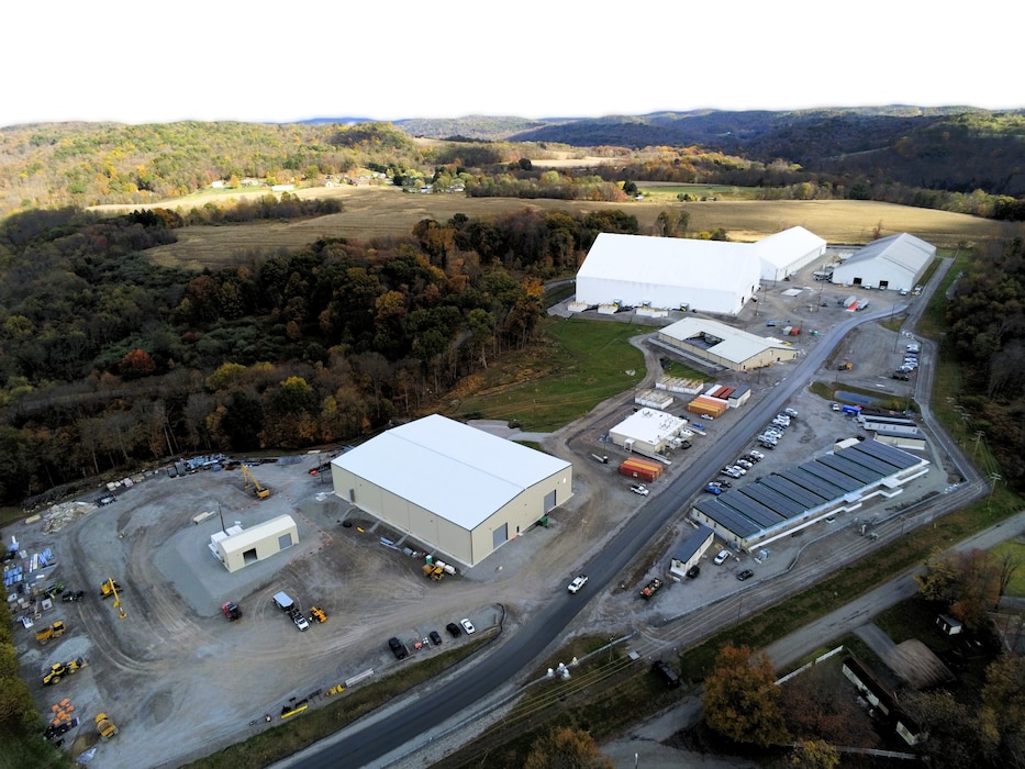 An aerial view of a construction site in the countryside.