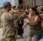 Soldiers from Troop A, 2nd Squadron, 106th Cavalry Regiment, receive an emotional welcome home from family following an overseas deployment.