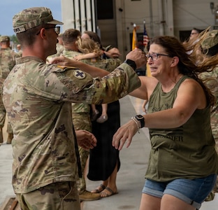 Soldiers from Troop A, 2nd Squadron, 106th Cavalry Regiment, receive an emotional welcome home from family following an overseas deployment.