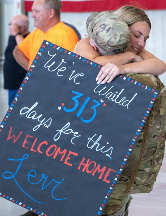 Soldiers from Troop A, 2nd Squadron, 106th Cavalry Regiment, receive an emotional welcome home from family following an overseas deployment..