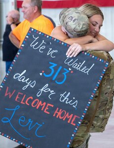 Soldiers from Troop A, 2nd Squadron, 106th Cavalry Regiment, receive an emotional welcome home from family following an overseas deployment..